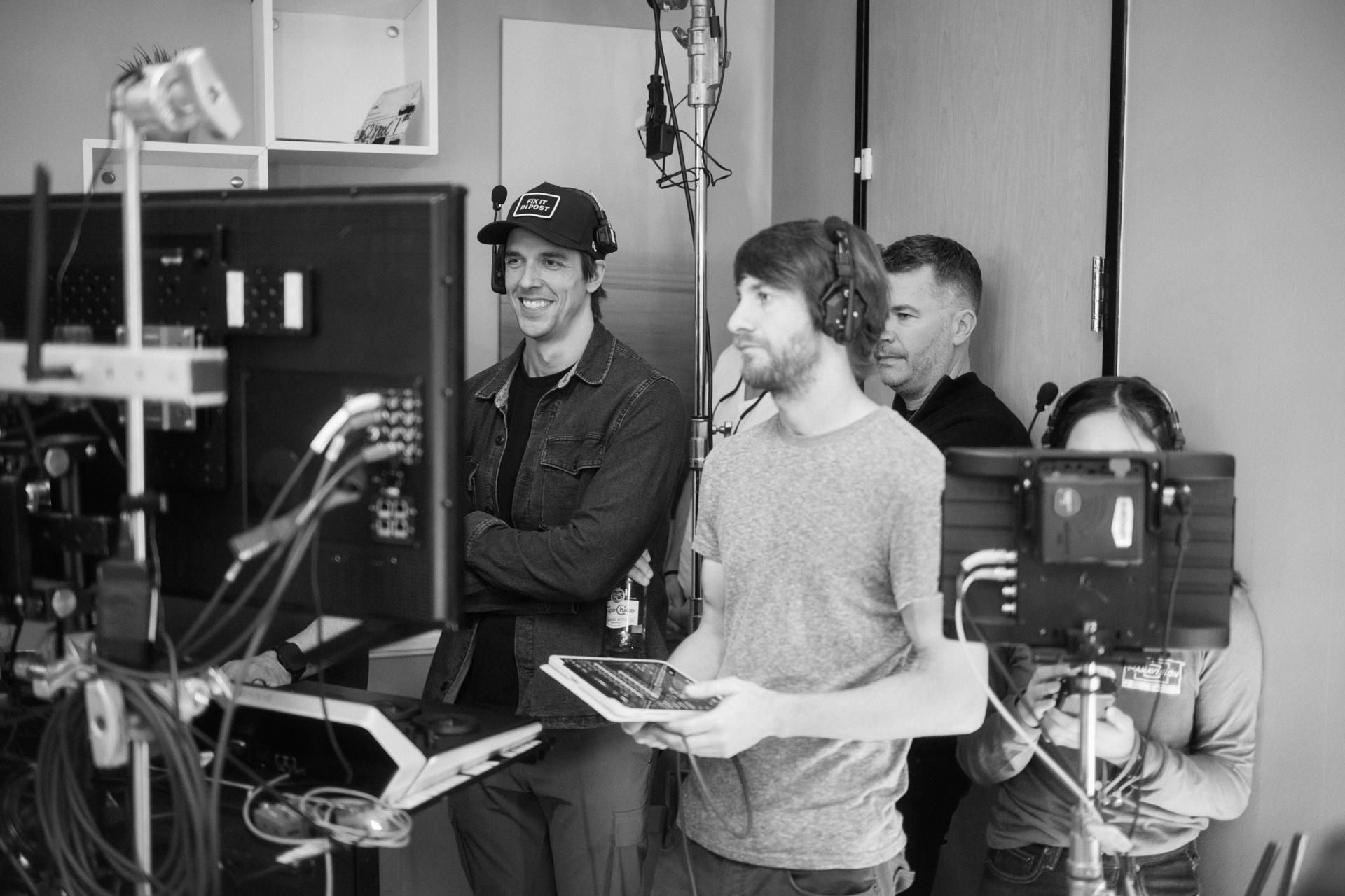 Taylor at video village on a studio shoot, watching the monitor with crew